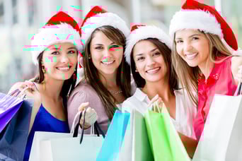 Happy group of women Christmas shopping at the mall