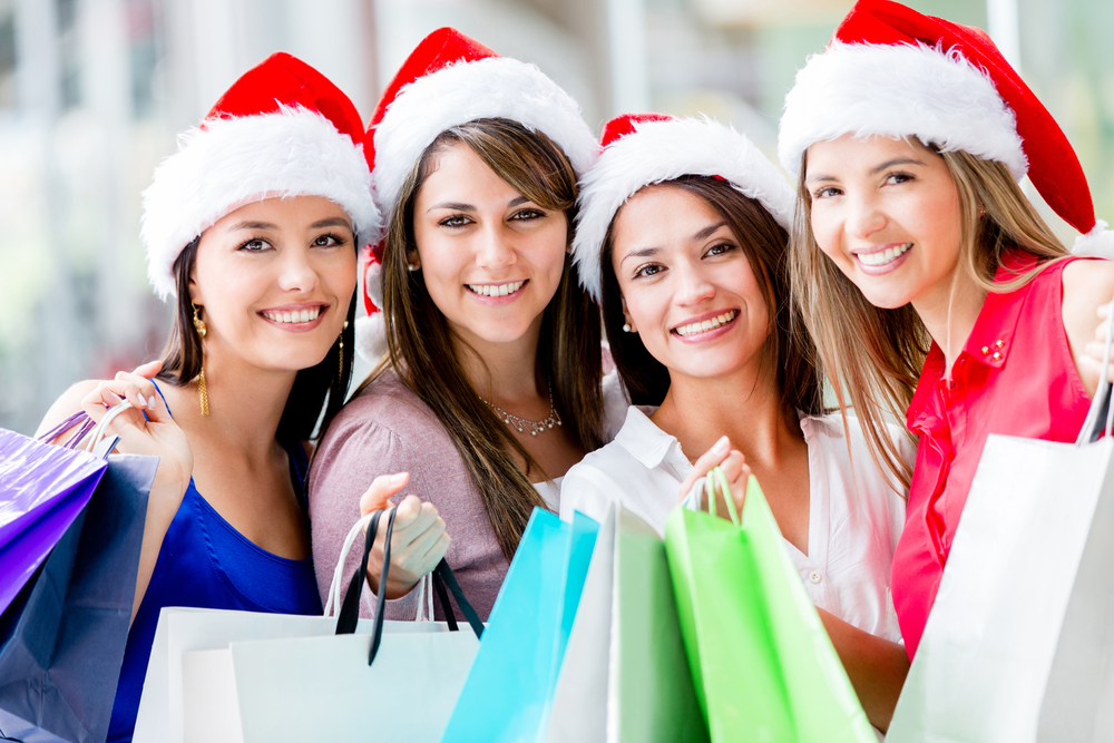 Happy group of women Christmas shopping at the mall